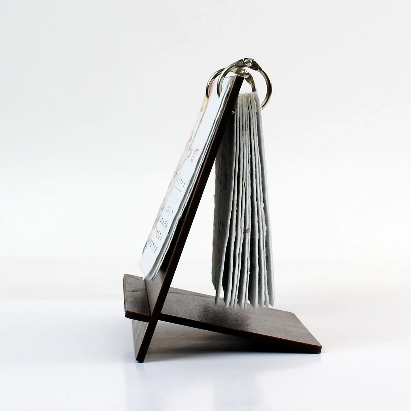 Side view of the B7 calendar's dark MDF stand and stacked seed-paper cards