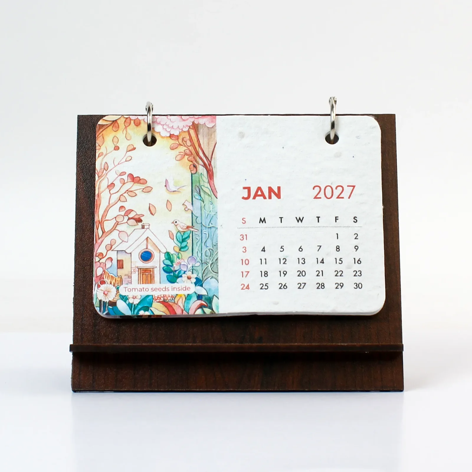 B7 plantable desk calendar with an illustrated January seed-paper card on a dark MDF stand