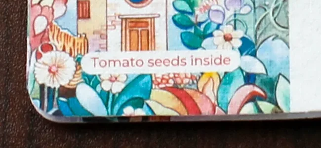 Printed Tomato seeds inside label on the January 2027 plantable calendar card