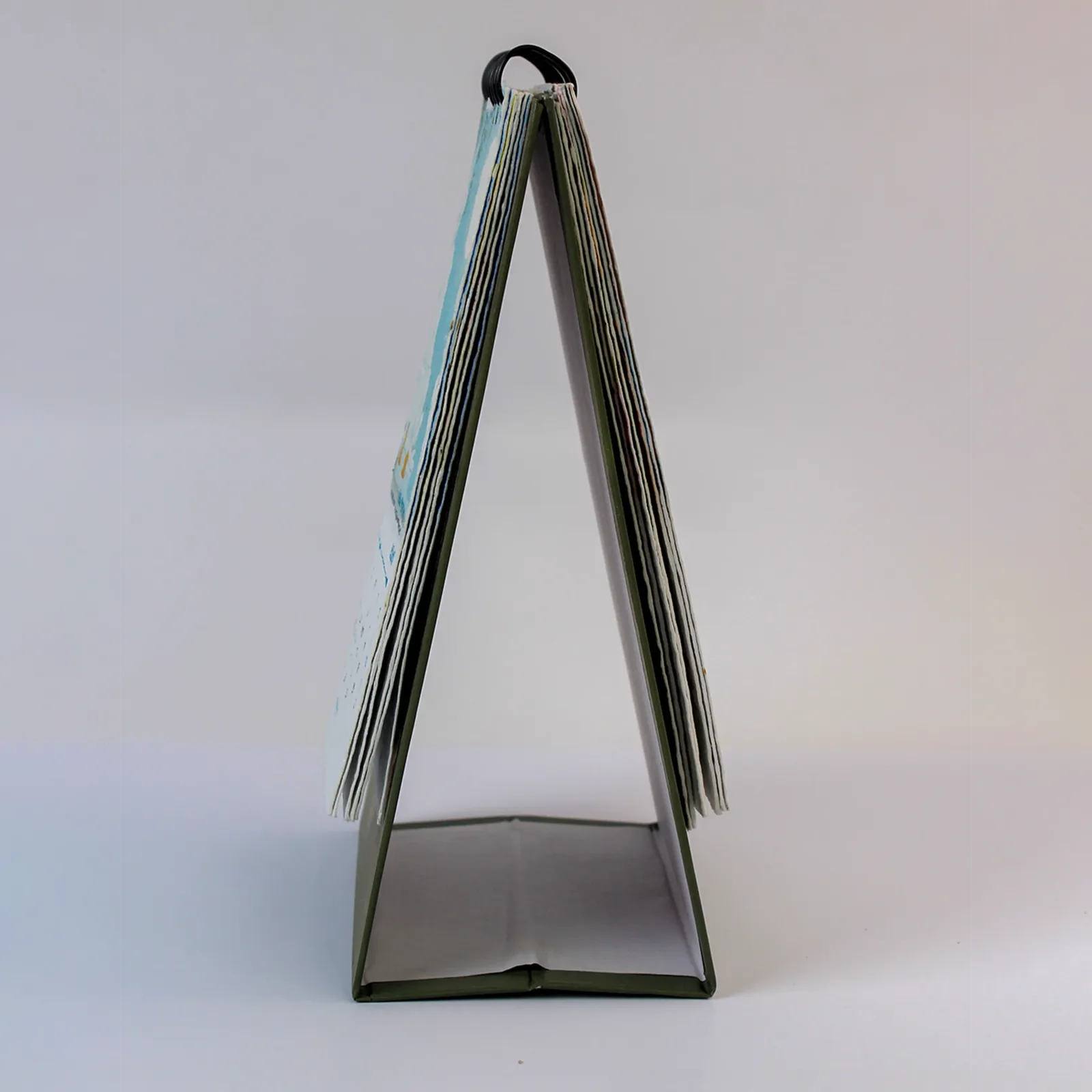 Side view of the B6 WireO portrait calendar showing its coiled binding and folding desk stand