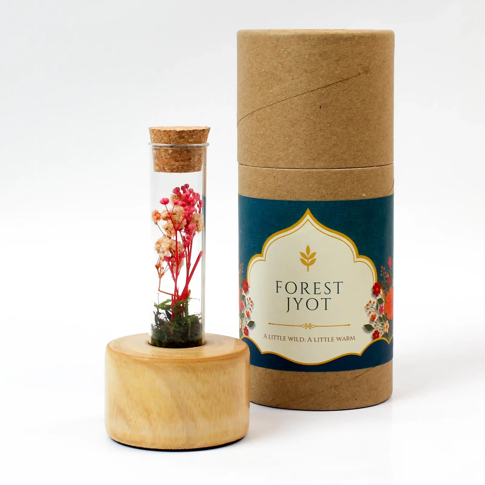 Forest Stump Tall glass bottle on a polished wooden base beside its Forest Jyot paper tube