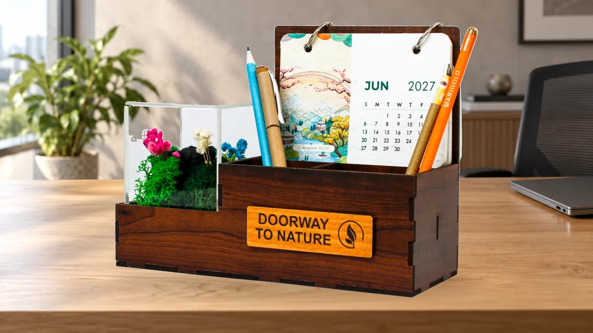 Terra Calendar Desk Organiser on a workstation with a June 2027 card, pens and an acrylic preserved forest