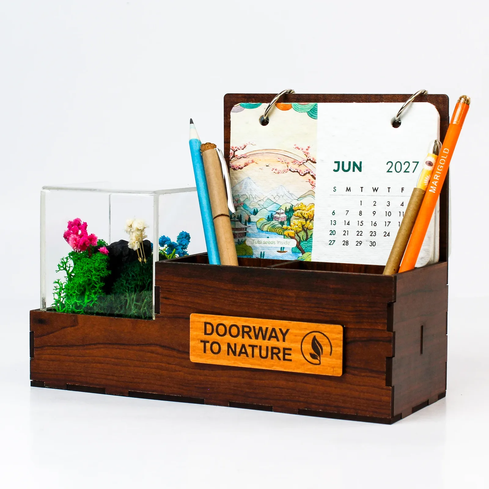 Dark MDF Terra desk organiser with a pen holder, June 2027 seed-paper calendar and acrylic forest chamber
