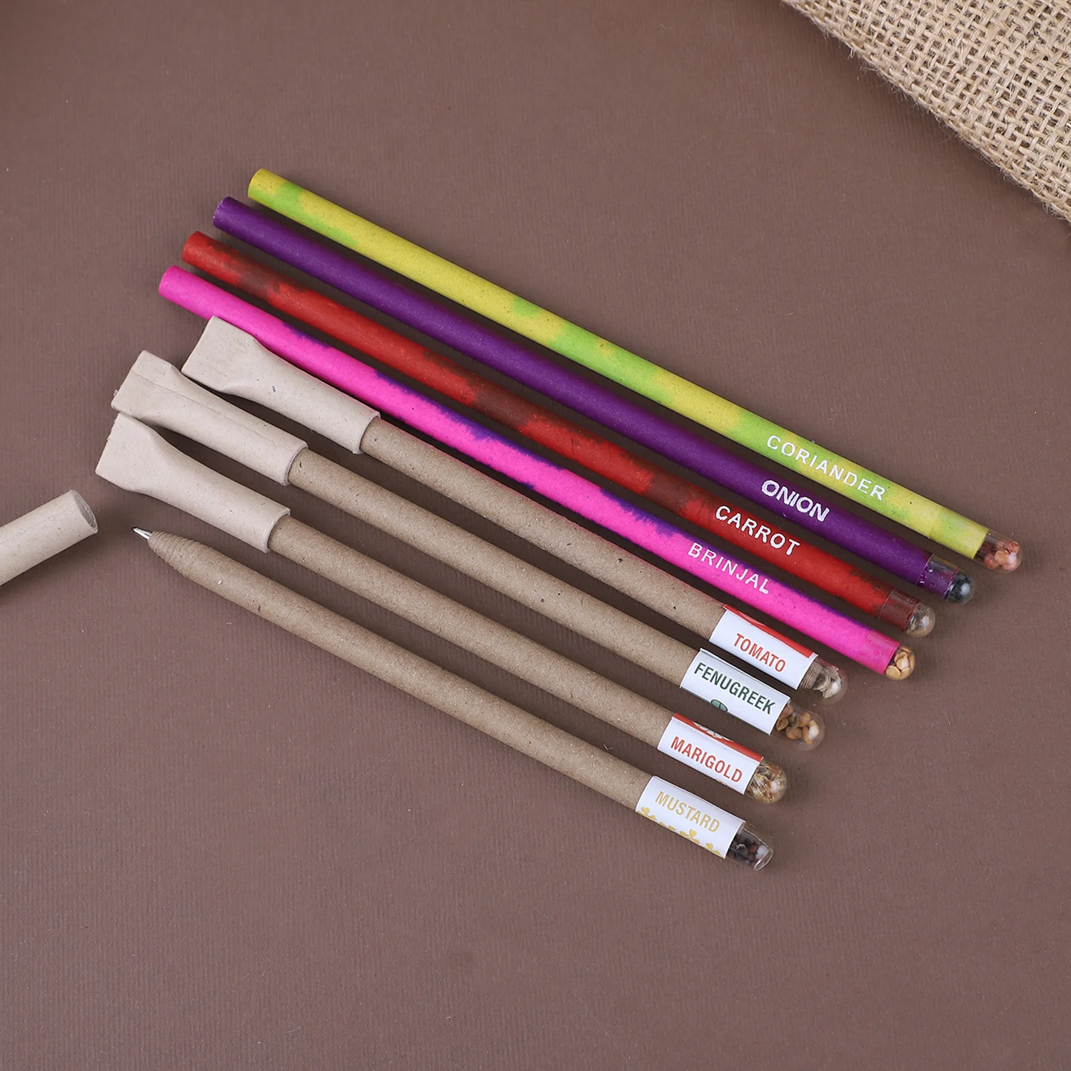 Plantable pens and pencils laid out with the seed variety printed on each piece